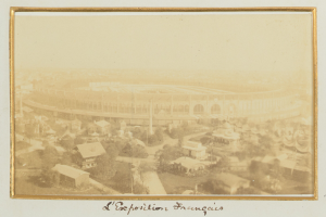 Altes Foto eines Stadions in einer städtischen Umgebung, umgeben von Gebäuden, Bäumen und Strommasten, mit Text unten.